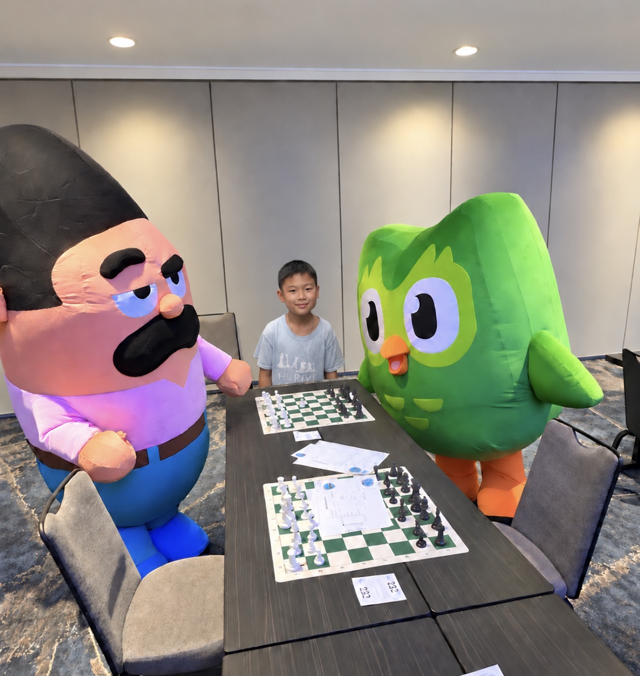 Young player at the board with tournament mascots