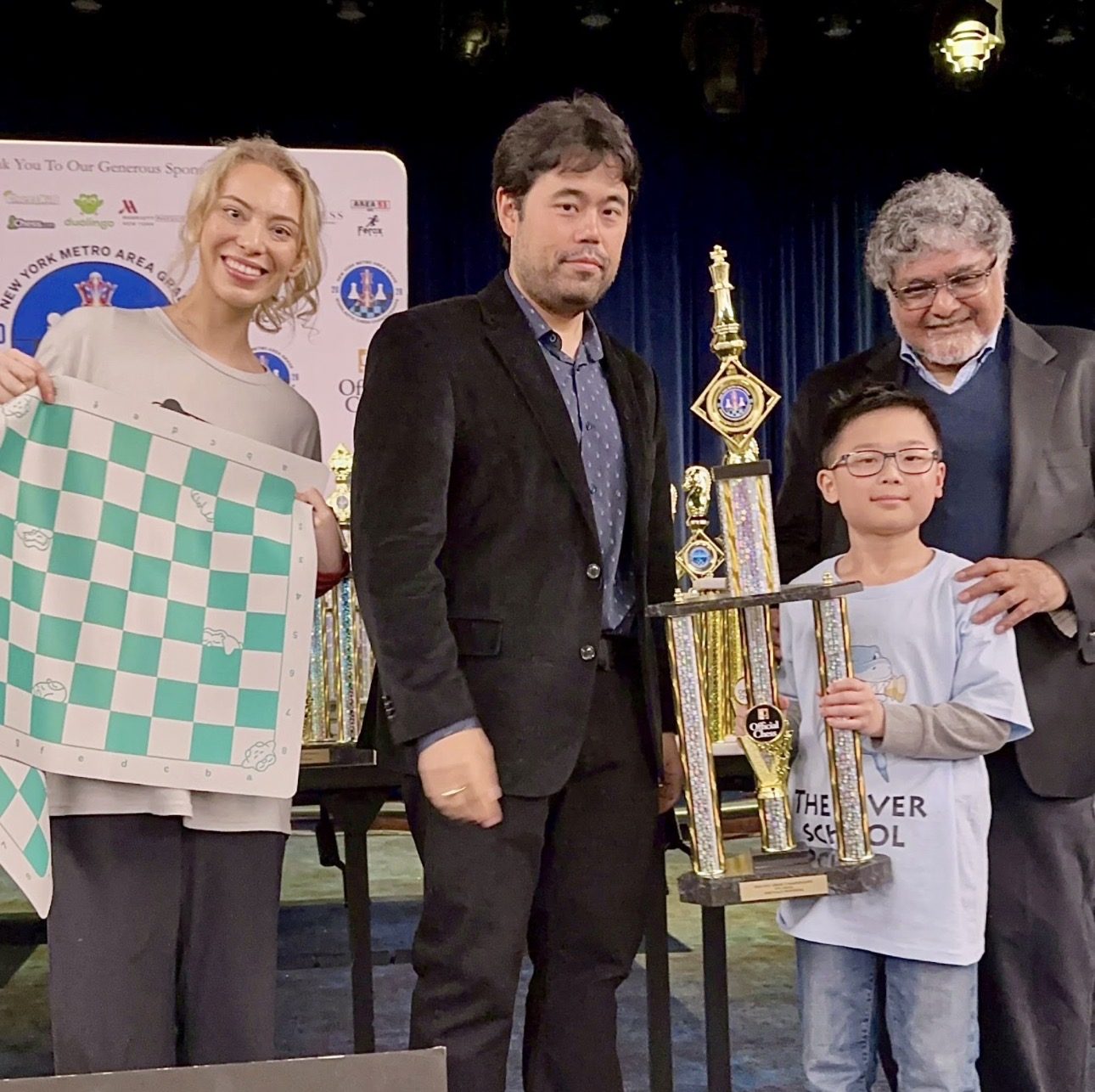 Young champion with his trophy on stage