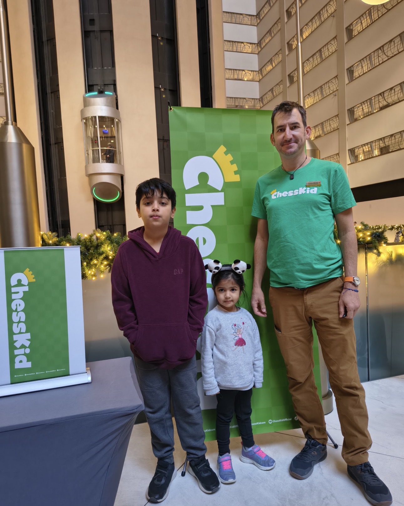 Players with a ChessKid banner at the event